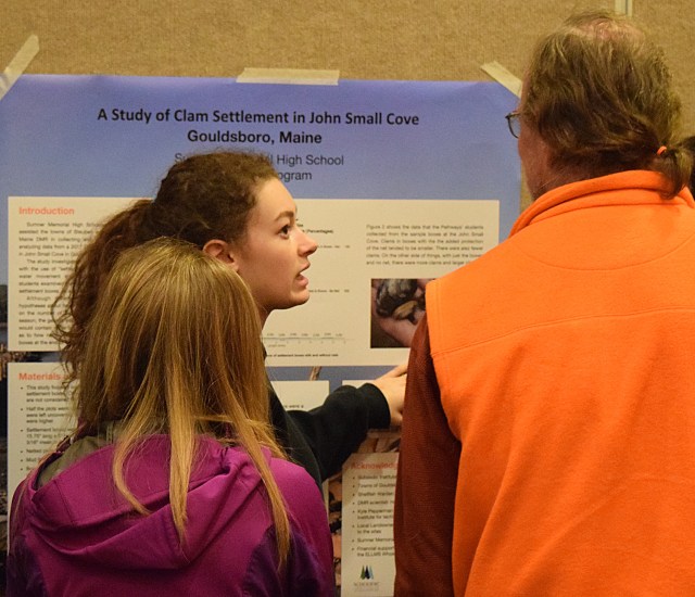 student explaining poster